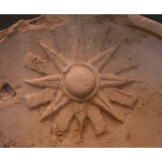 Top of stele, libation scene before a seated god, sun symbol